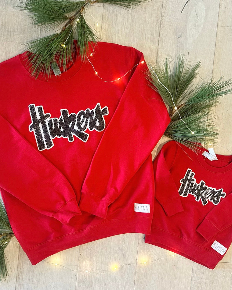 BLACK SPARKLE/ WHITE HUSKERS - RED GILDAN CREWNECK (TODDLER + YOUTH + ADULT)