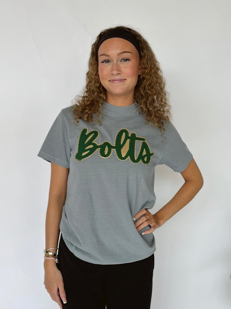 CURSIVE GREEN/GOLD METALLIC BOLTS - GREY TEE
