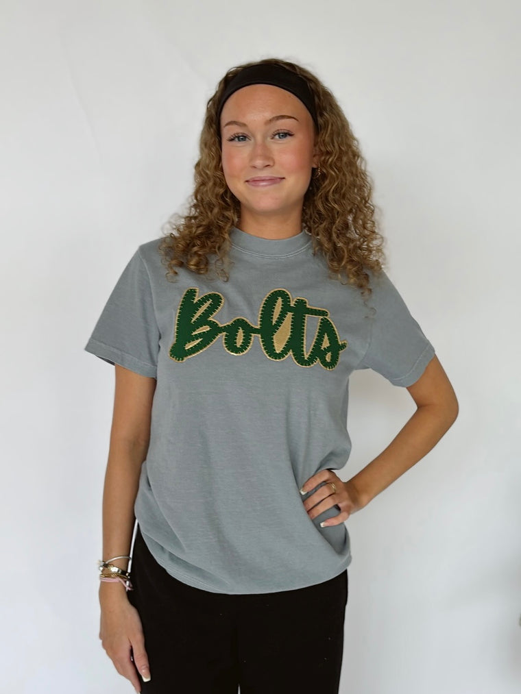 CURSIVE GREEN/GOLD METALLIC BOLTS - GREY TEE