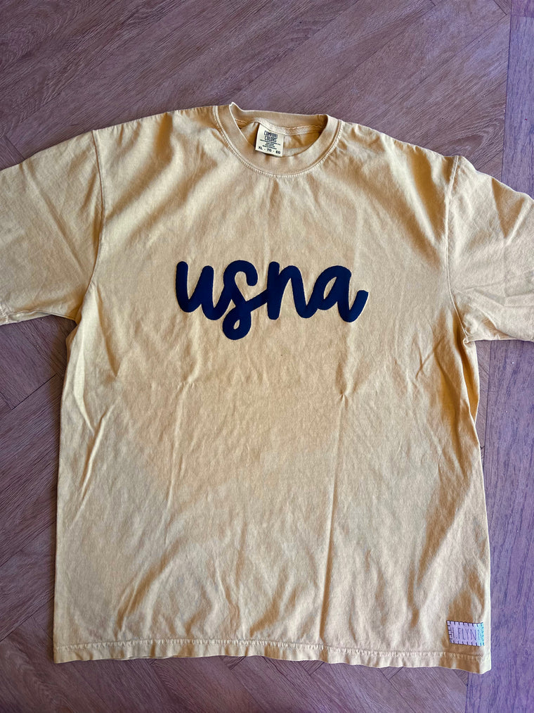 NAVY CURSIVE USNA - MUSTARD COMFORT COLORS TEE