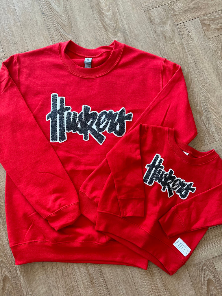 BLACK SPARKLE/ WHITE HUSKERS - RED GILDAN CREWNECK (TODDLER + YOUTH + ADULT)