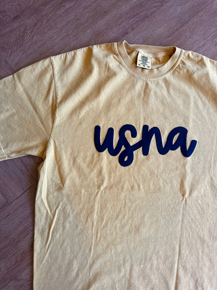 NAVY CURSIVE USNA - MUSTARD COMFORT COLORS TEE