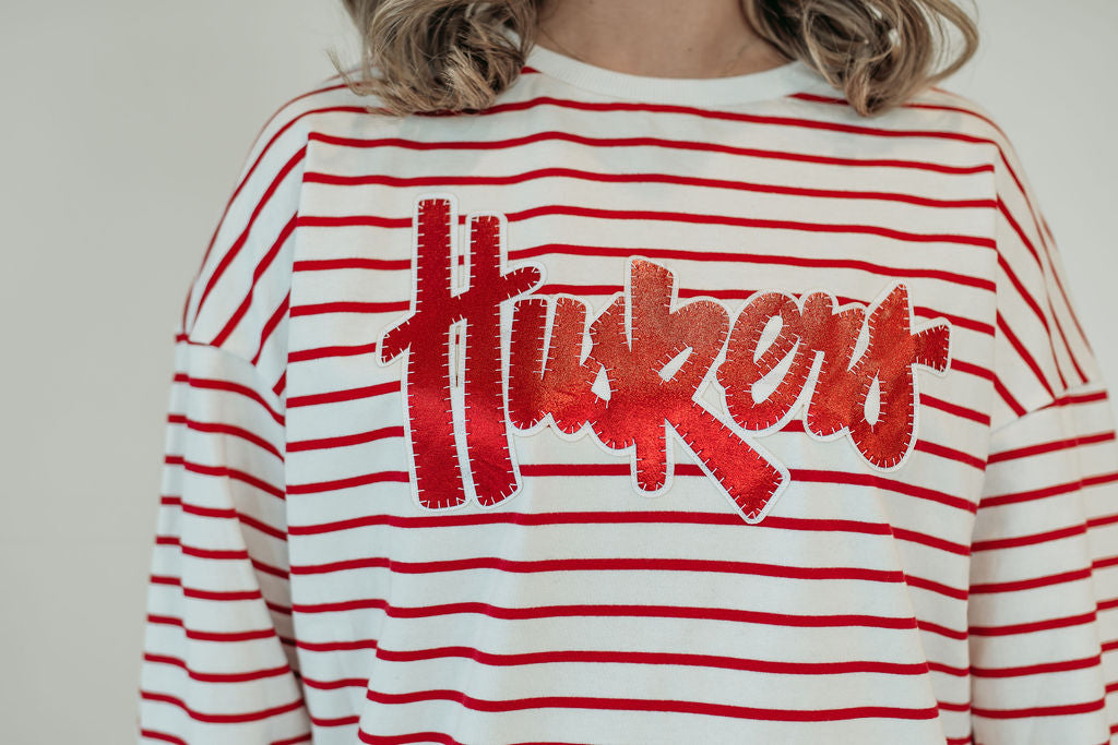 RED METALLIC/WHITE HUSKERS SCRIPT - RED STRIPED CREWNECK