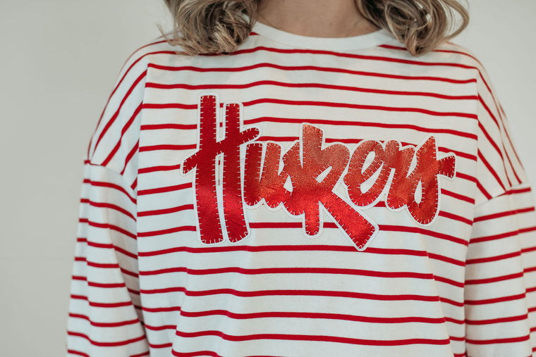 RED METALLIC/WHITE HUSKERS SCRIPT - RED STRIPED CREWNECK