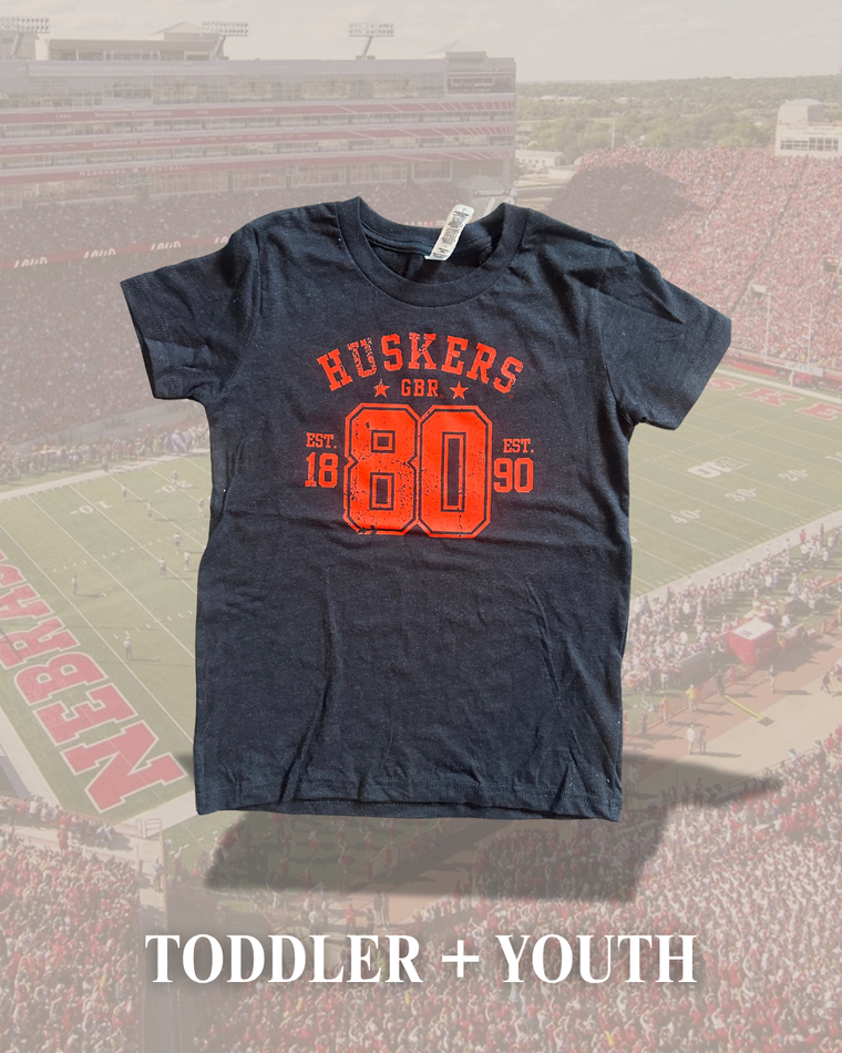 RED HUSKERS 80 TRANSFER DESIGN -  BLACK TEE (TODDLER + YOUTH)