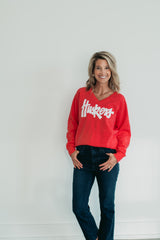 WHITE SPARKLE HUSKERS SCRIPT - RED V-NECK SWEATSHIRT