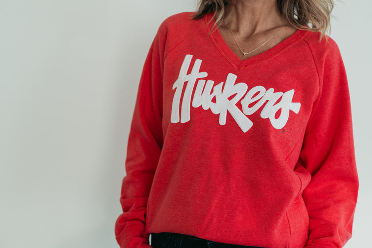WHITE SPARKLE HUSKERS SCRIPT - RED V-NECK SWEATSHIRT