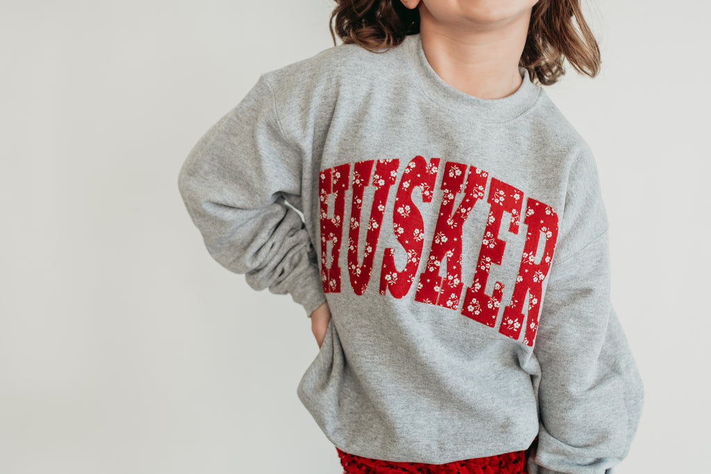 VARSITY RED DAINTY FLORAL HUSKERS - ASH GREY CREWNECK (YOUTH + ADULT)