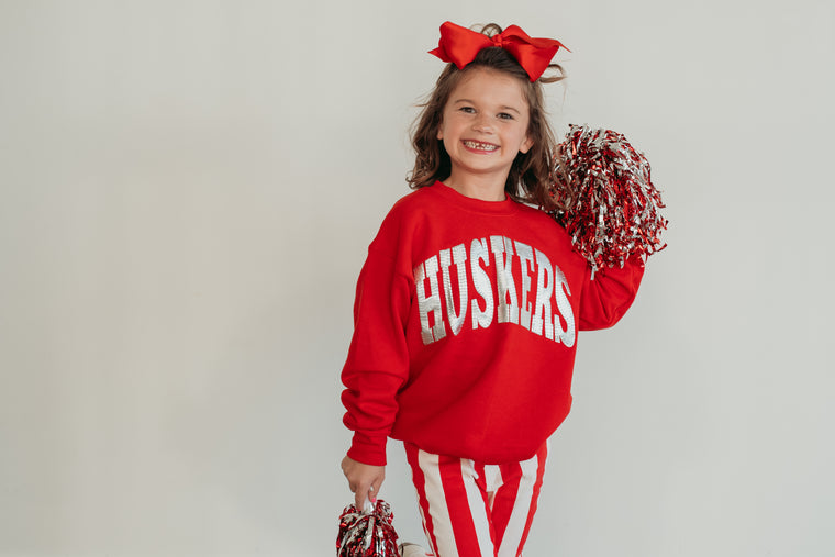 VARSITY SILVER METALLIC HUSKERS - RED CREWNECK (TODDLER + YOUTH)