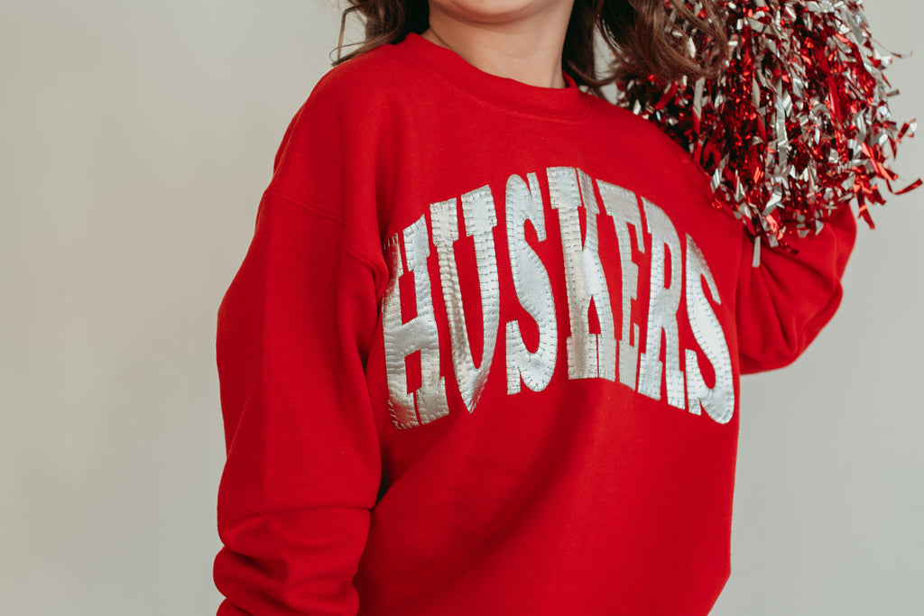 VARSITY SILVER METALLIC HUSKERS - RED CREWNECK (TODDLER + YOUTH)