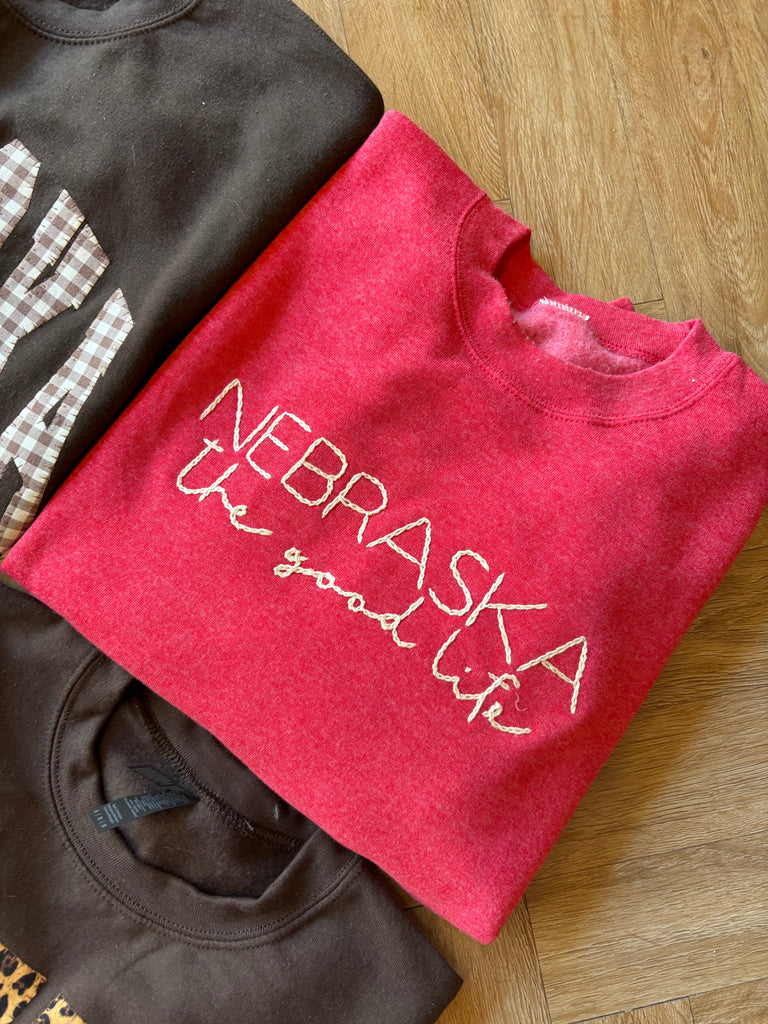 EMBROIDERED NEBRASKA THE GOOD LIFE - SCARLET CREWNECK