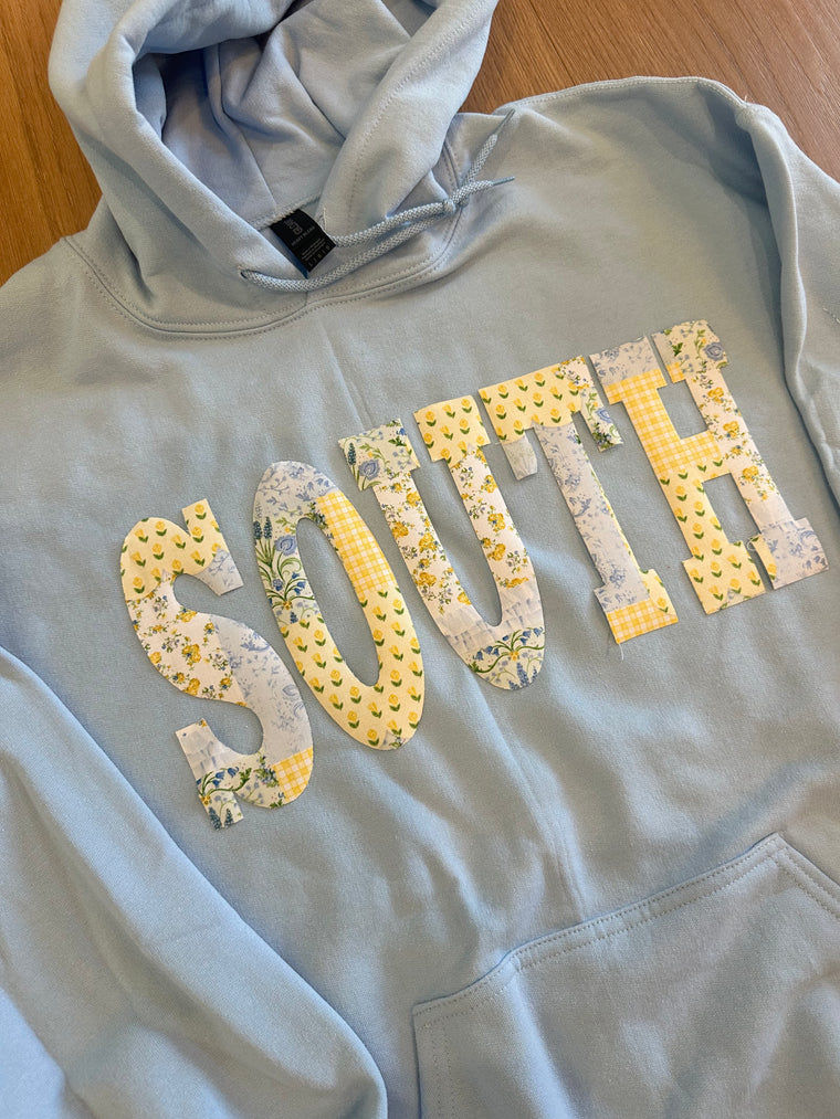 YELLOW + BLUE PATCHWORK SOUTH  - LIGHT BLUE HOODIE