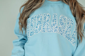 NEBRASKA (BLUE FLORAL + WHITE BACKING) - LIGHT BLUE CREWNECK