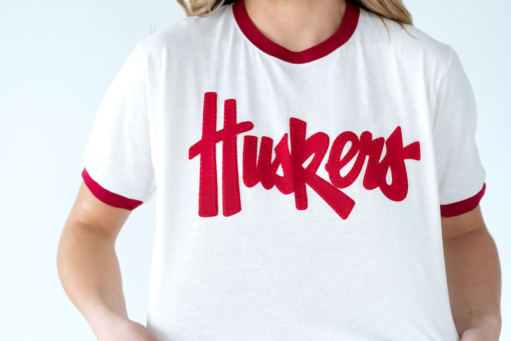 RED HUSKERS SCRIPT - IVORY RINGER TEE